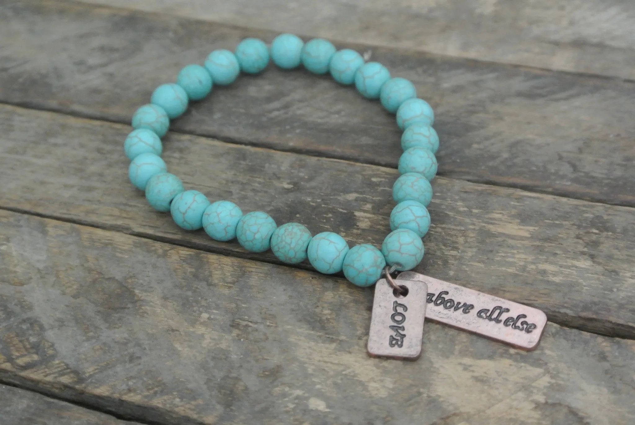 Turquoise beaded bracelet with Copper toned Love Above All Else Charm